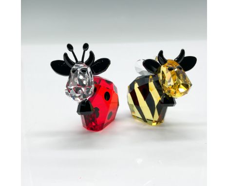 This lot features two whimsical Swarovski crystal cow figurines, Ladybug and Bumblebee, part of the Mo Limited Edition series