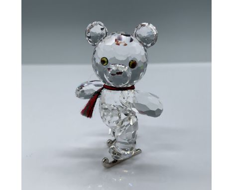 Swarovski Kris Bear crystal figurine featuring an ice-skating pose, adorned with a charming red scarf and intricate crystal d