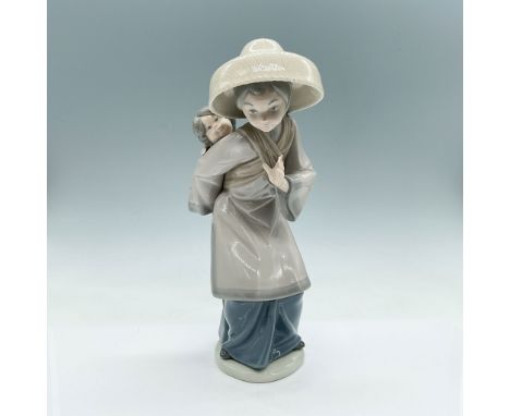 Lladro porcelain figurine titled "My Precious Bundle," item number 01005123. This figurine depicts a young woman wearing a tr