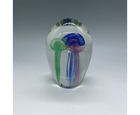 Captivating jellyfish paperweight featuring vibrant green, blue, and pink jellyfish suspended within a clear oval body. Intri