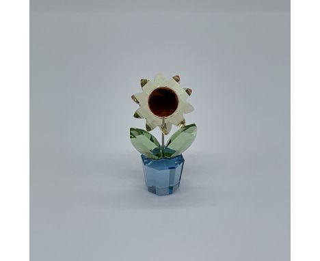 A stunning Swarovski crystal figurine representing a delicate sunflower, expertly crafted with intricate detailing. This piec