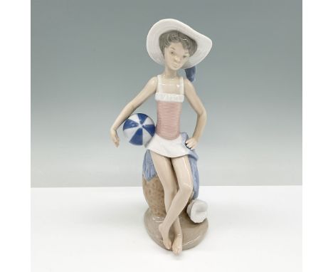 A delightful Lladro porcelain figurine titled Summer, model number 01005219. This piece portrays a young girl seated elegantl