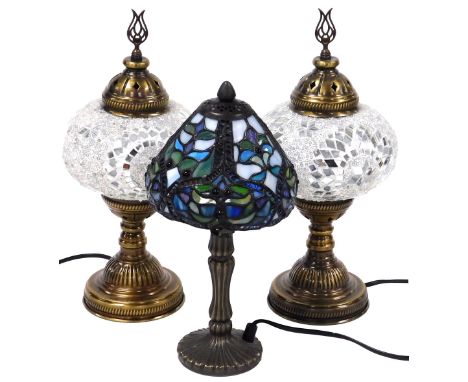 A pair of Turkish lacquered brass and mirrored glass decorated table lamps, 35cm high, together with a Tiffany style table la
