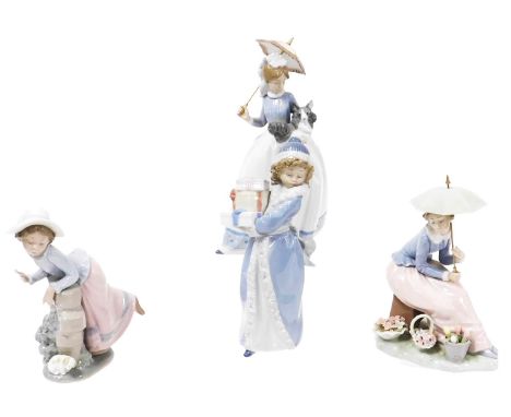 Four Nao porcelain figures, comprising a seated lady with parasol, girl leaning over a wall looking at a puppy, a lady with p