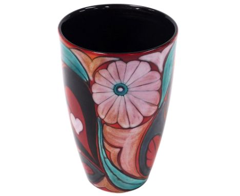 A Poole Pottery vase, designed by Lorna Whitmarsh, of tapering form, decorated with flowers and hearts, on a mottled orange a