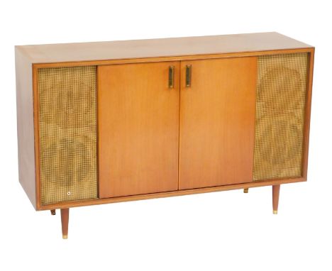 A mid century teak radiogram, with two doors, containing a Murphy radio, record player lacking, and recesses for records, fla