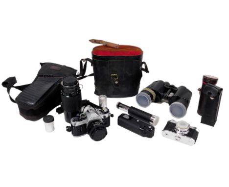 A Canon A1 camera, zoom lens fd70-210mm, Halina Pet camera, Canon Power Winder, three draw telescope, and a pair of Regent 10