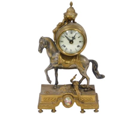 An Imperial brass cased mantel clock, circular enamel dial bearing Roman numerals, eight day movement, the case of barrel for
