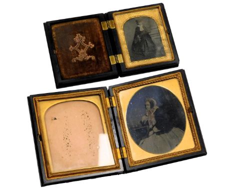Two 19thC ambrotype portrait photographs, of ladies, one modelled standing, the other coloured and modelled seated, in emboss