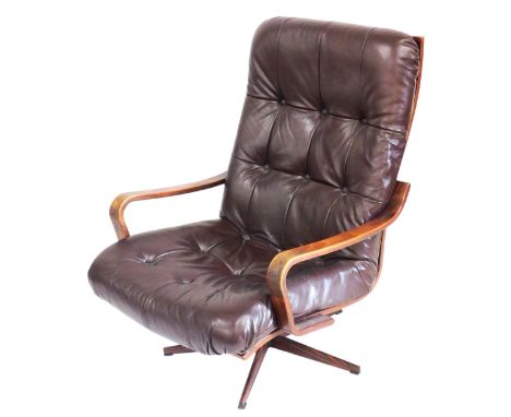 A mid century bentwood and brown leather swivel armchair, probably Ekornes of Norway, with button back seat and back, raised 