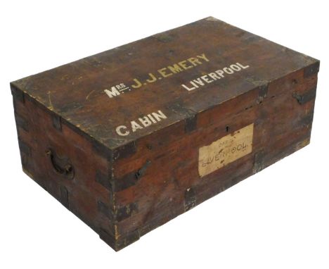 An early 20thC stained pine cabin trunk, with cast iron strapwork, the lid named for Mrs J. J. Emery, Liverpool, 32cm x 81cm 