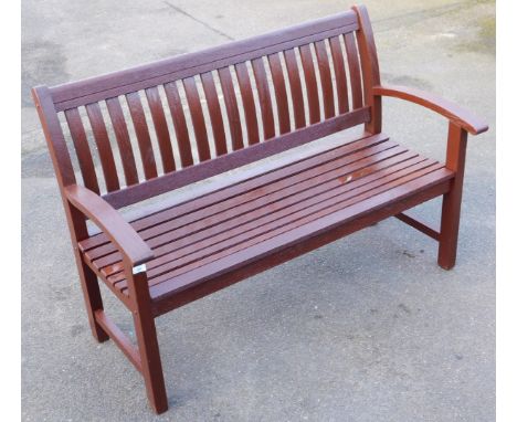 A dark stained oak wooden three seater bench, 140cm wide.