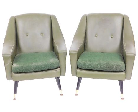 A pair of mid century green leather armchairs, with button backs, and loose cushion seats, raised on ebonised turned legs, br