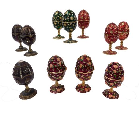 Eleven Faberge style brass and enamel musical egg boxes, with hinged lids, each opening to reveal a fitted interior, 12cm hig