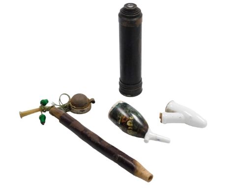 A two draw telescope, together with an Alpine porcelain and wooden handled pipe, decorated with deer, and a further porcelain
