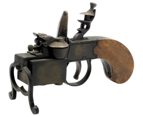 A Dunhill flintlock tinder pistol table lighter, with a wooden stock, 15cm wide. 
