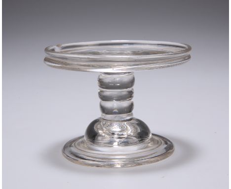 AN 18TH CENTURY GLASS PATCH STAND, the galleried circular tray raised on a knopped stem continuing to a domed and folded foot