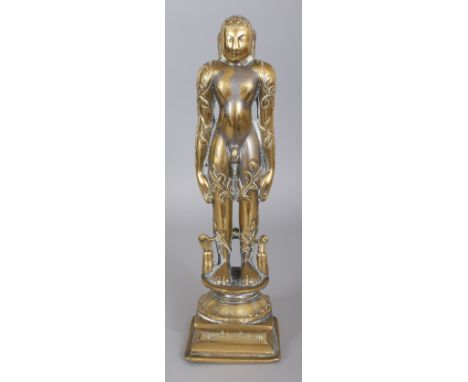 A 19TH CENTURY SOUTH-EAST ASIAN POLISHED BRONZE FIGURE OF A STANDING LEAF SHROUDED DEITY, standing on an inscribed base, 12.7