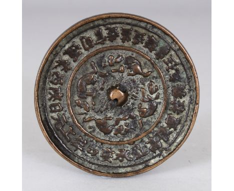 A CHINESE MING DYNASTY BRONZE MIRROR, its rim cast with a border of characters, 3.4in diameter.