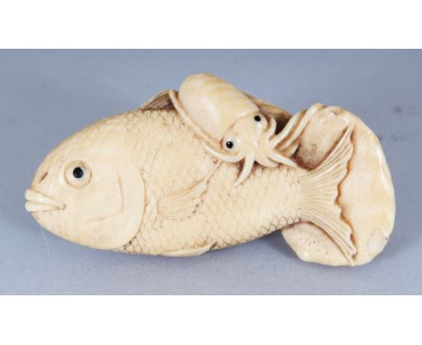 A JAPANESE MEIJI PERIOD IVORY NETSUKE OF TWO FISH & A SQUID, the details naturalistically carved, 2.2in wide.