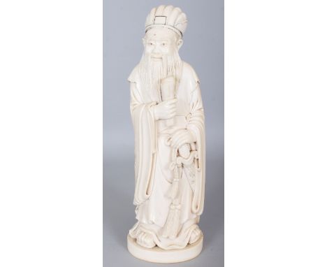 A GOOD LARGE EARLY 20TH CENTURY CHINESE CARVED IVORY FIGURE OF A STANDING WARRIOR SAGE, weighing approx. 1.73Kg, holding a cl