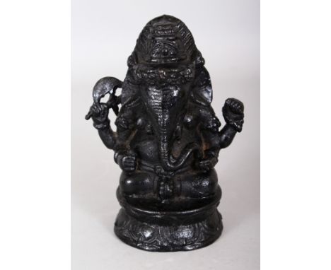 AN INDIAN LACQUERED BRONZE FIGURE OF GANESHA, the elephant-head deity seated on a double lotus plinth, 5.6in high.