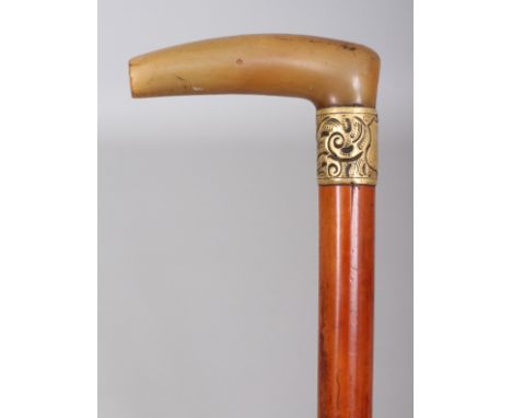 A HORN HANDLED MALACCA WALKING STICK, with an engraved shield centred metal collar, the horn possibly rhinoceros horn, 32.75i