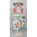 A LARGE EARLY 20TH CENTURY CHINESE FAMILLE ROSE PORCELAIN VASE, the sides painted with a