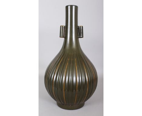 A LARGE CHINESE TEA DUST PORCELAIN ARROW VASE, with fluted sides, the base moulded with a Qianlong seal mark, 17.2in high.