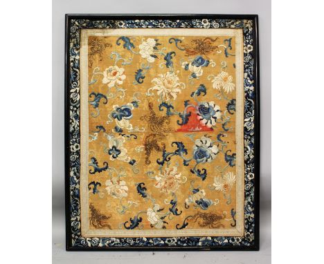 A LARGE 19TH CENTURY CHINESE WOOD FRAMED ORANGE GROUND EMBROIDERED SILK PANEL, decorated with scroll-stemmed fruit and peony,