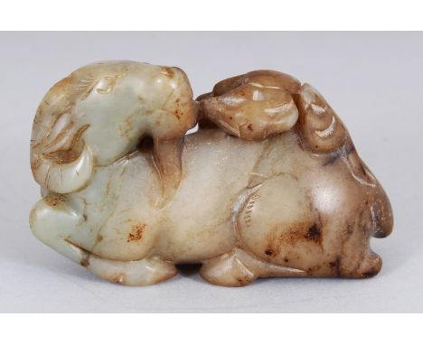 AN ARCHAIC STYLE JADE CARVING OF A RAM, its back with cloud scrolls, 3.3in wide & 2.1in high.