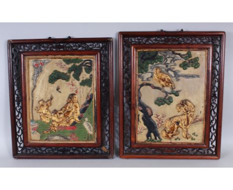 A NEAR PAIR OF EARLY 20TH CENTURY CHINESE PAINTED SOAPSTONE PLAQUES, in pierced wood frames, one plaque decorated with a tige