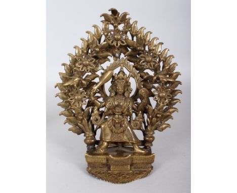 A NEPALESE OR INDIAN BRONZE FIGURE OF A DEITY, standing before an elaborate detachable mandorla, 7.5in wide & 9.25in high ove