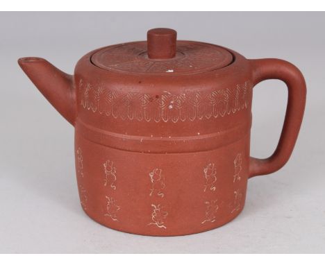 A 19TH CENTURY CHINESE YIXING POTTERY TEAPOT & COVER, the cover moulded with ribboned emblems, the sides incised with calligr