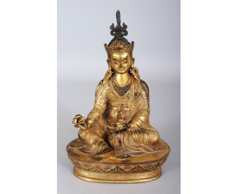 A SINO-TIBETAN GILT BRONZE FIGURE OF A KARMAPA, seated on a lotus plinth and bearing a vajra and a kapala, the base with a do