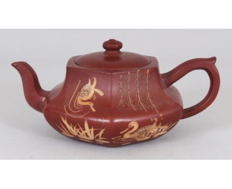 A CHINESE YIXING POTTERY SLIP DECORATED TEAPOT & COVER, the base with an impressed seal mark, 6.25in long including handle an