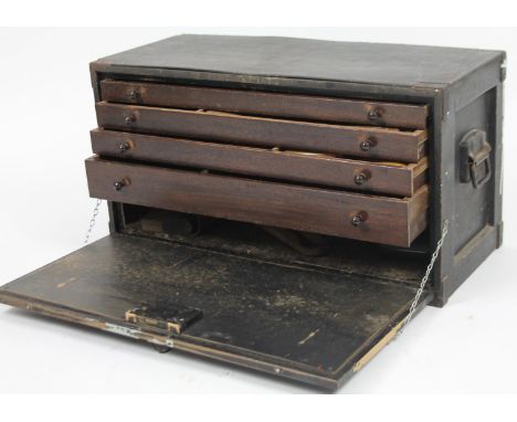 An early 20thC ebonised tradesman's tool cabinet, of rectangular outline, the hinged front revealing three drawers, containin