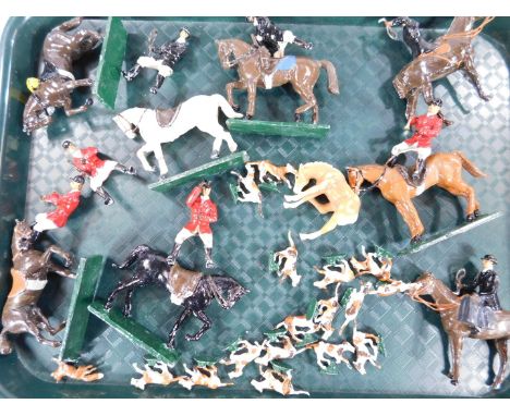 An early 20thC lead hunting group set, to include hounds, various huntsman, 9cm H, etc, to include red and black jacketed exa