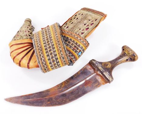 A Middle Eastern Jambiya dagger, with curved blade and elaborate scabbard, 97cm W.