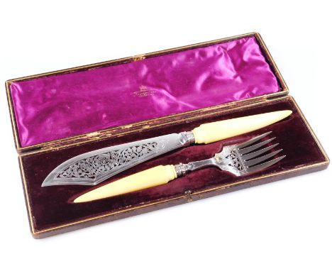 A pair of Edwardian silver plated and ivory fish servers, each with pierced bright cut blades, comprising of a fork 29cm wide