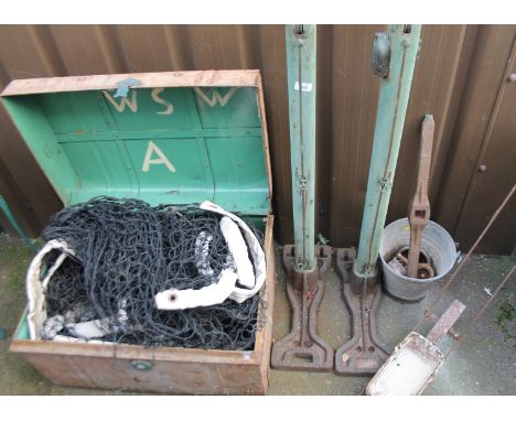 A vintage lawn tennis set, comprising tennis net, net posts and line markers.