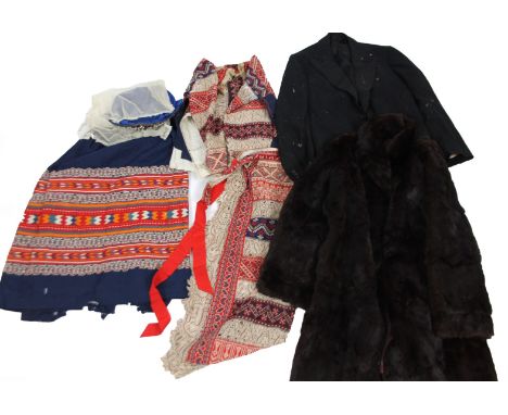 An early 20thC Russian peasant's wedding dress, formed as material garments in various colours, a fur coat and a hunting styl