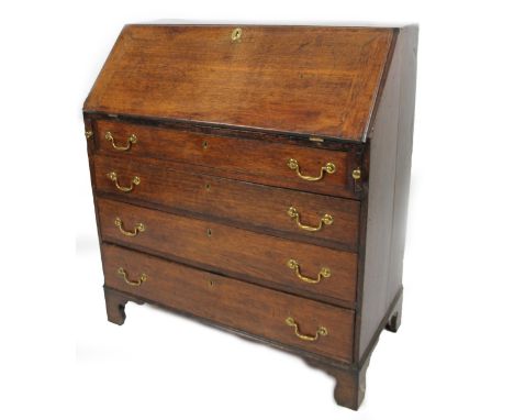 A George III oak bureau, the fall front revealing a part fitted interior with cupboard, pigeon holes and drawers, above four 