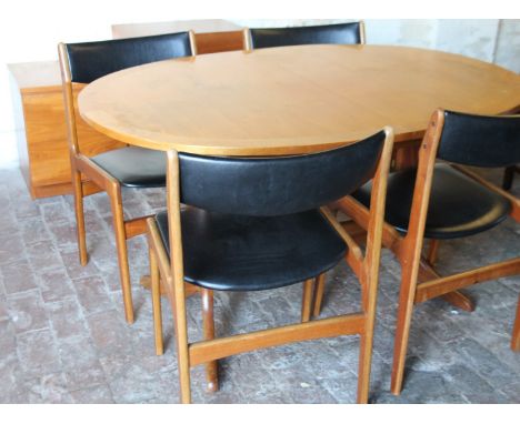 A 1970s vintage Nathan teak extending oval dining table, with four dining chairs, a matching four door low cupboard set with 