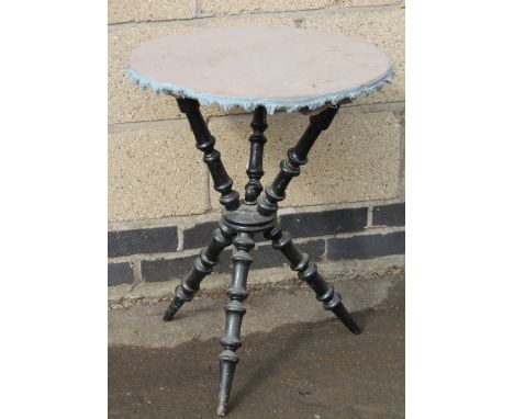 An early 20thC fortune teller's table, the part embroidered top raised on bobbin turned cross supports, centred by a circular