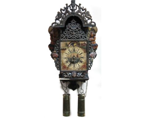 A 20thC decorative wall clock, with pierced metal casing, Roman numeric dial and moon roller movement, with 12cm W back plate