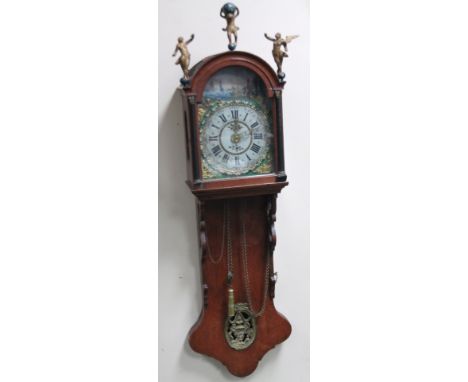 An early 20thC oak 'Act of Parliament' face clock, with tin arch dial, painted, decorated and raised with 29cm W, with a Roma