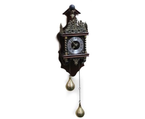 A 20thC Dutch stoelklok, with metal pierced scroll mounts, the 12cm dia. chapter ring flanked by barleytwist columns, on a wo