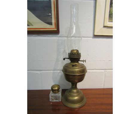 A brass based oil lamp and a glass inkwell with brass lid 