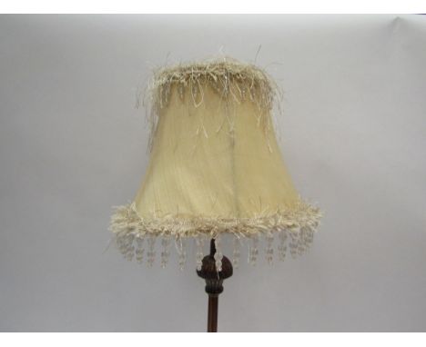 A modern table lamp, bronzed metal base with feathered effect and beaded shade 